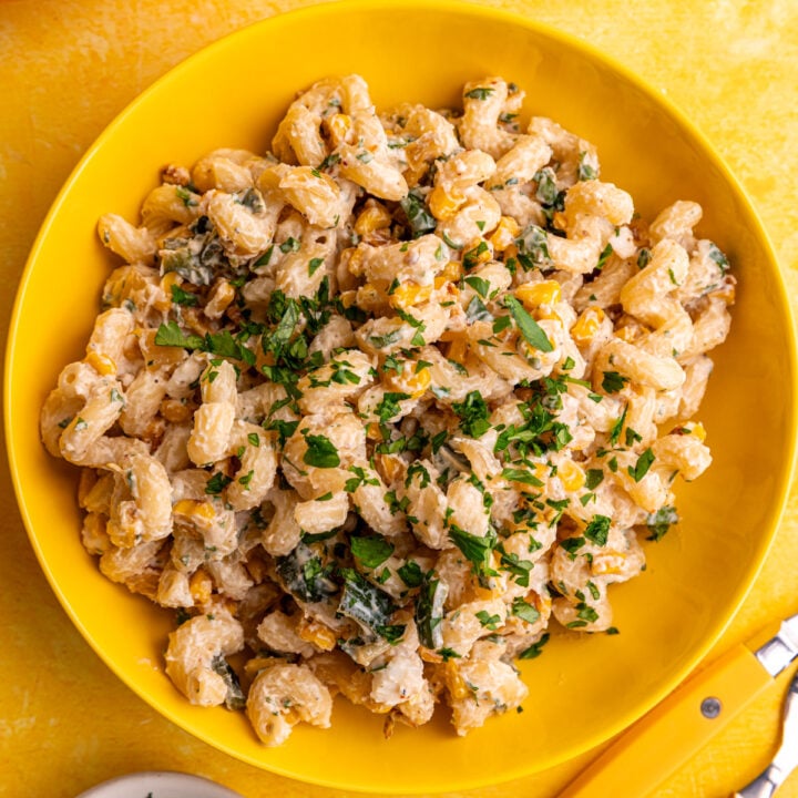 A bowl of vegan elote corn pasta salad, garnished with cilantro.