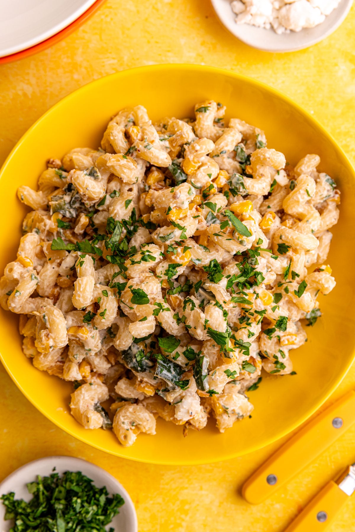 A bowl of vegan elote corn pasta salad, garnished with cilantro.