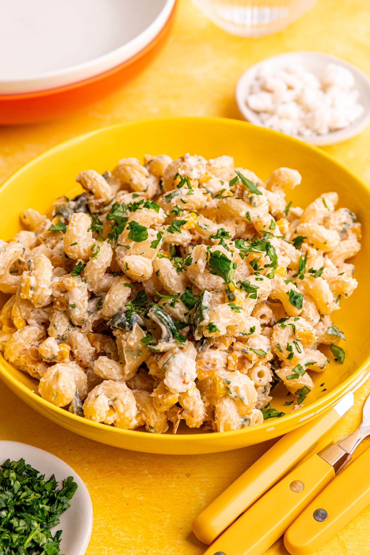A bowl of vegan elote corn pasta salad, garnished with cilantro.