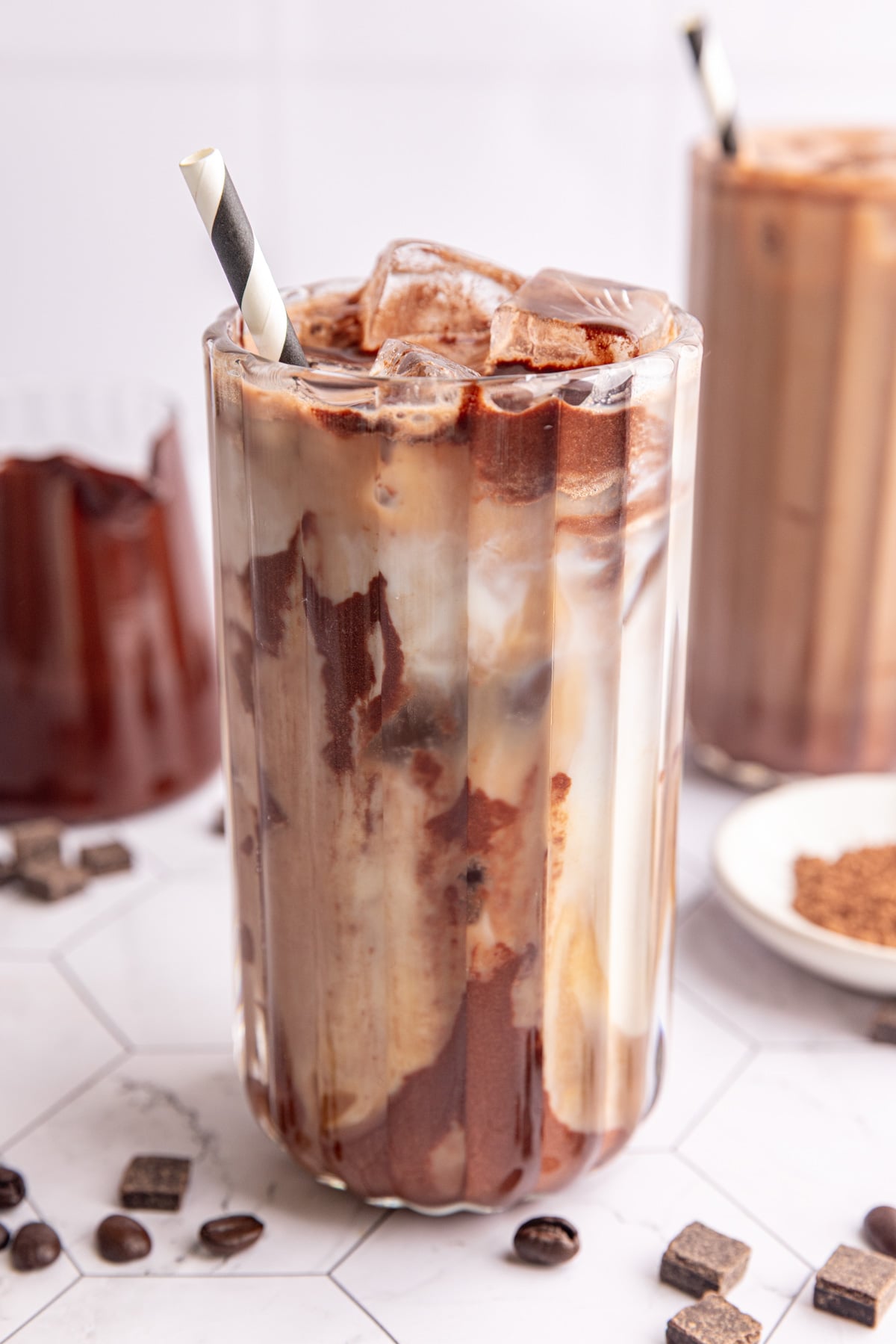 A vegan iced mocha, swirled with chocolate syrup.