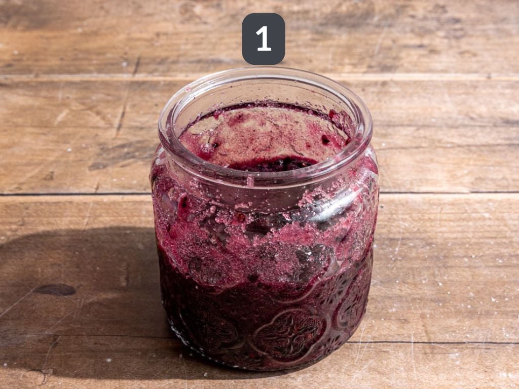 Blackberry shrub step 1 - mix the sugar and blackberries.