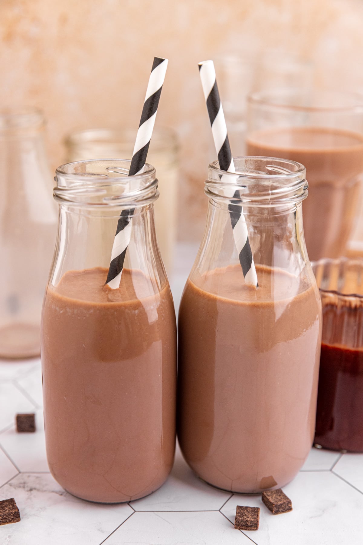 Two milk bottles of vegan chocolate milk.