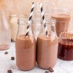 Two milk bottles of vegan chocolate milk.