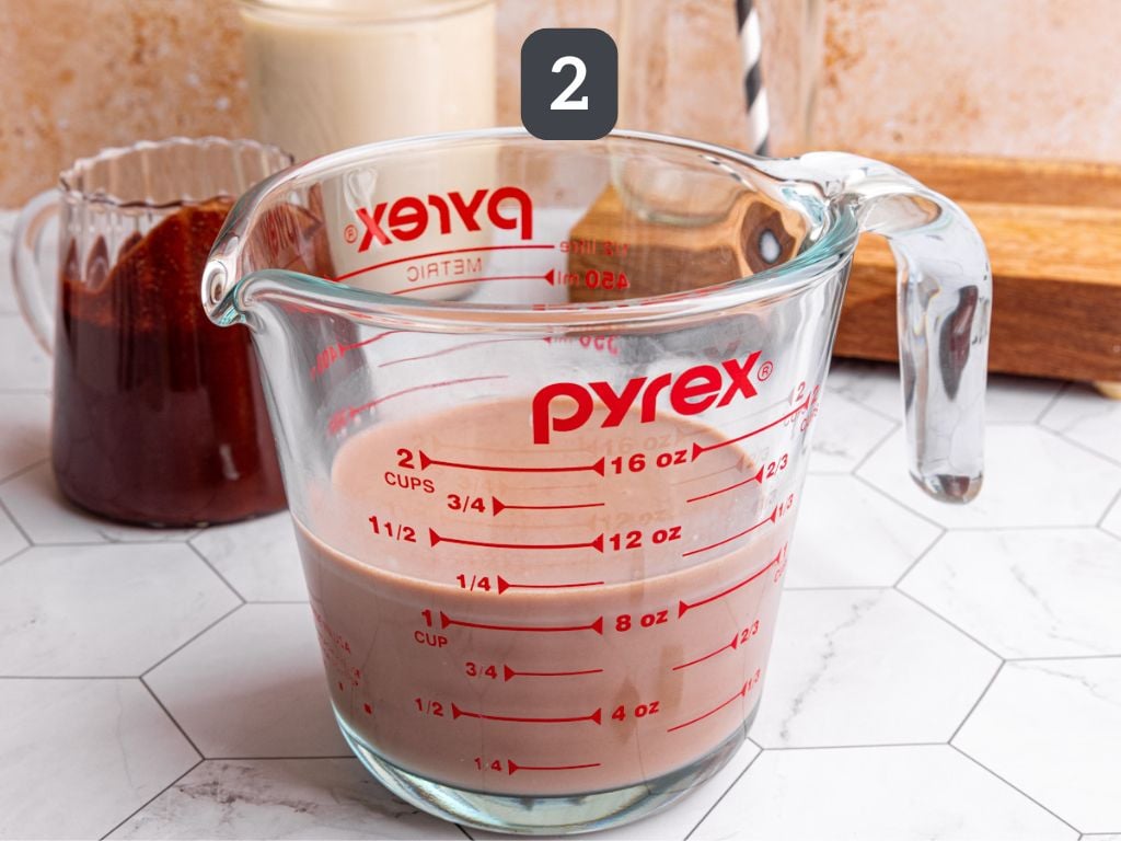 Homemade vegan chocolate milk step 2 - whisk the syrup and milk