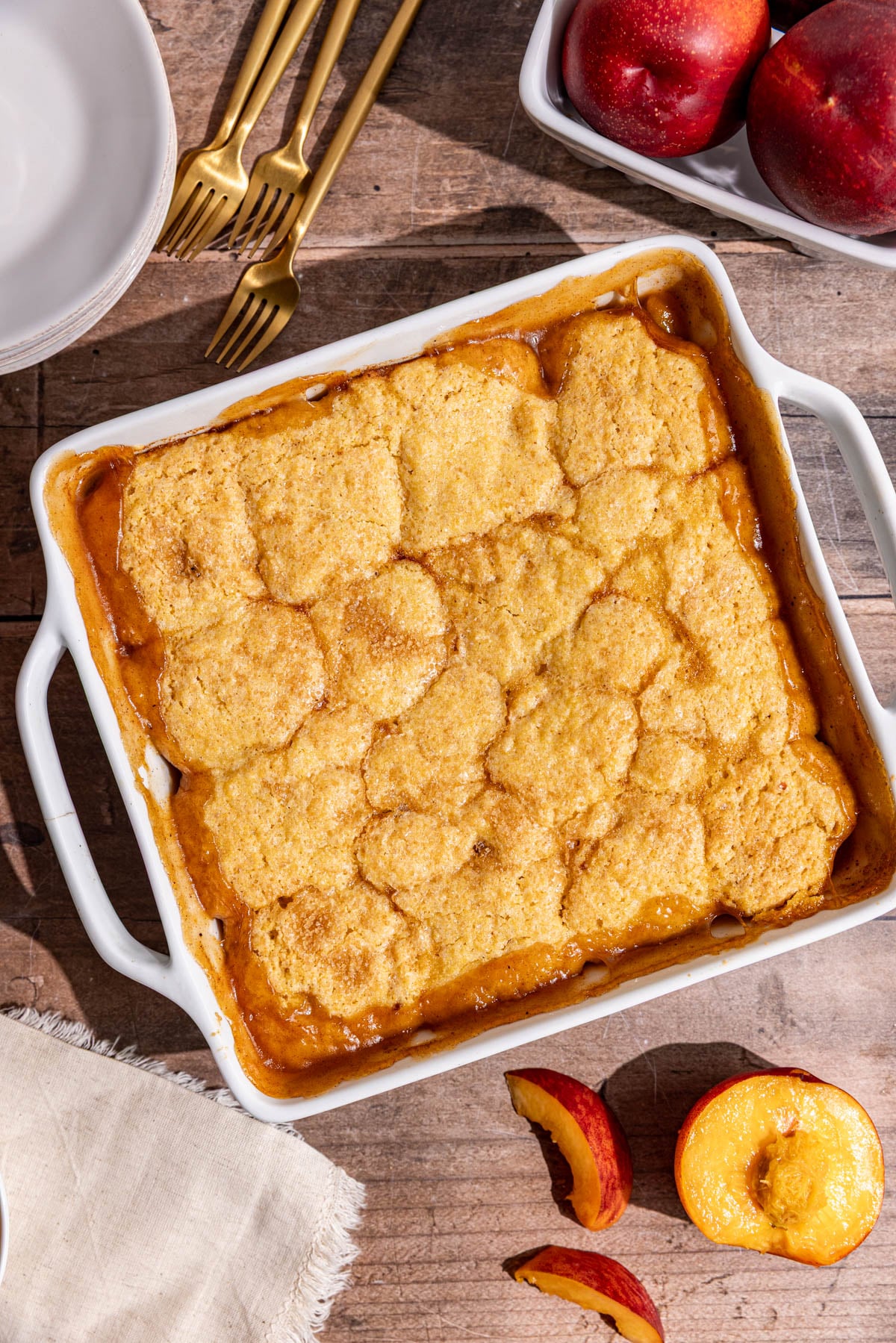 A baked vegan cornmeal peach cobbler.