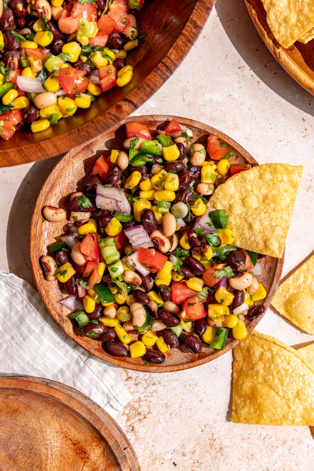A plate of vegan cowboy caviar, with a few tortilla chips.
