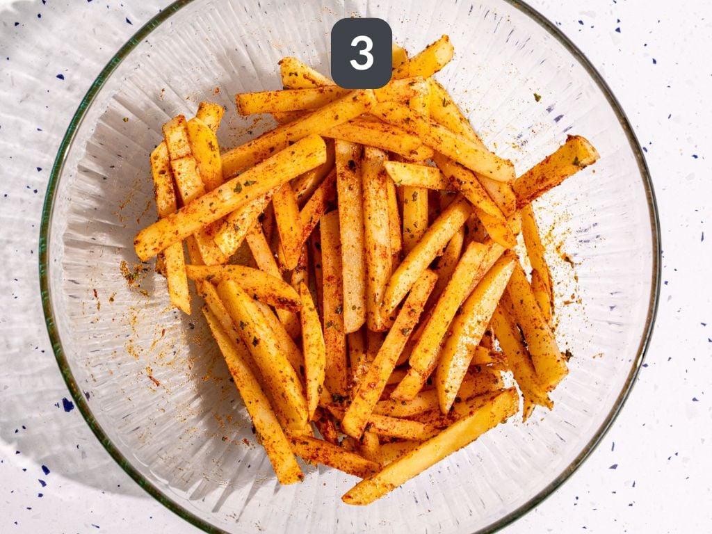 Loaded greek feta fries step 3 - toss with oil and spices