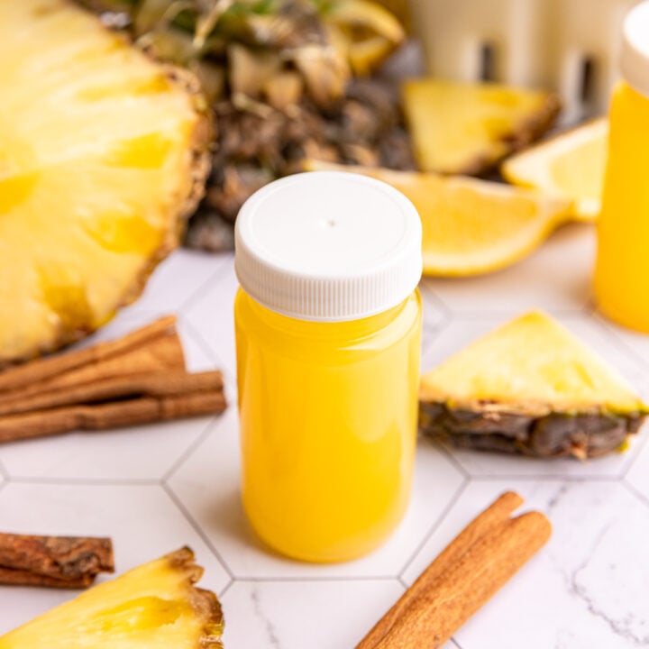 A small juice bottle of pineapple cinnamon wellness shot.