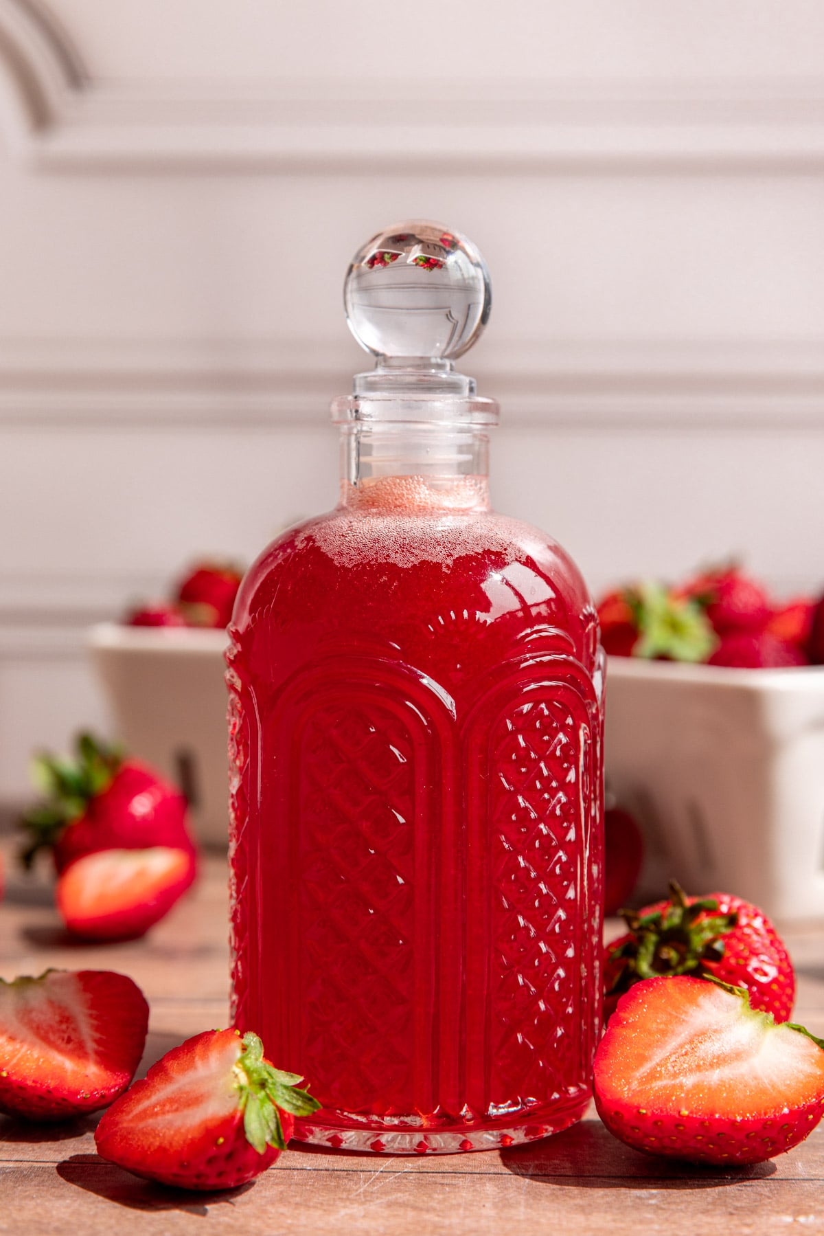 A bottle of strawberry syrup.