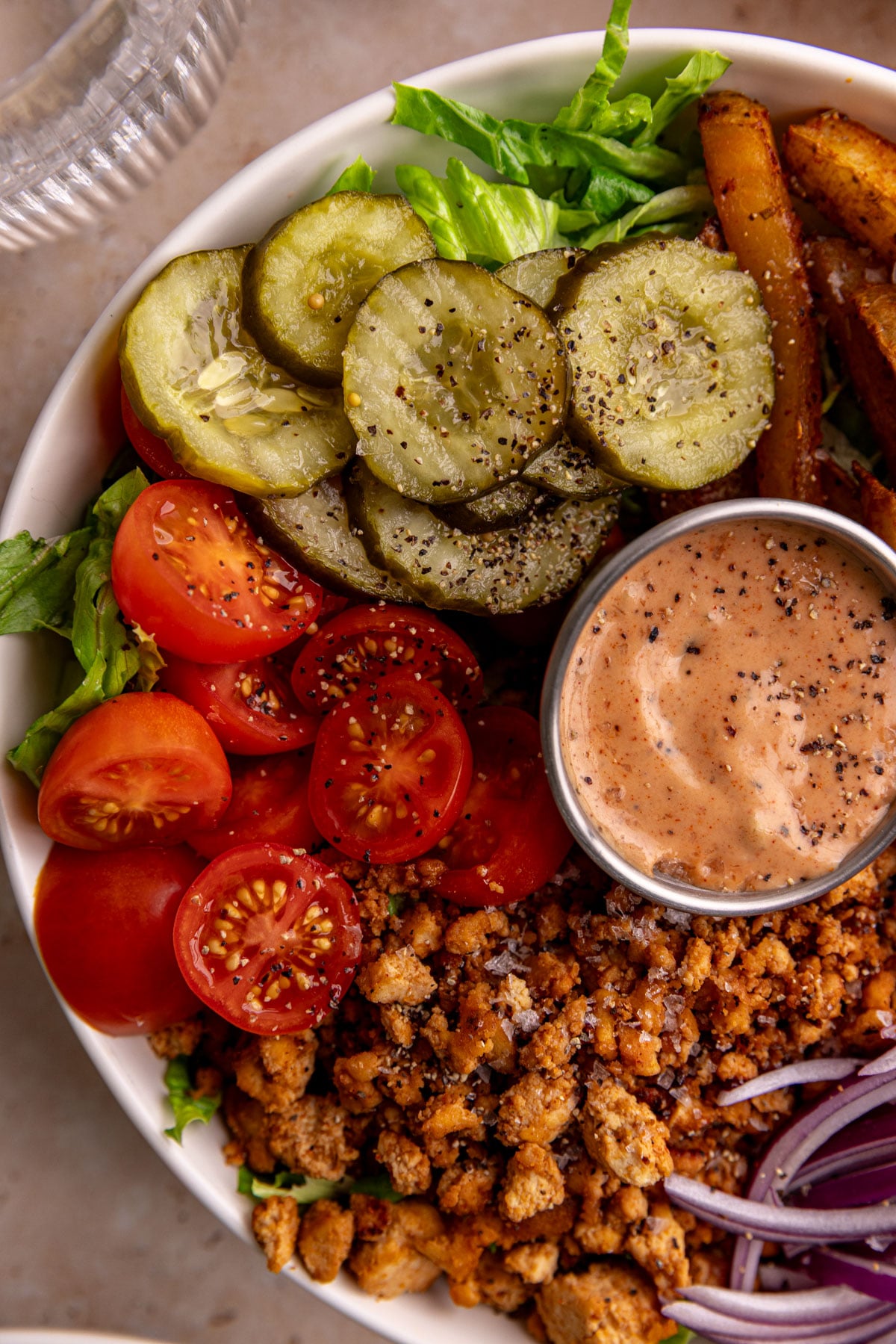 A close up view of the veggies in a vegan burger bowl.
