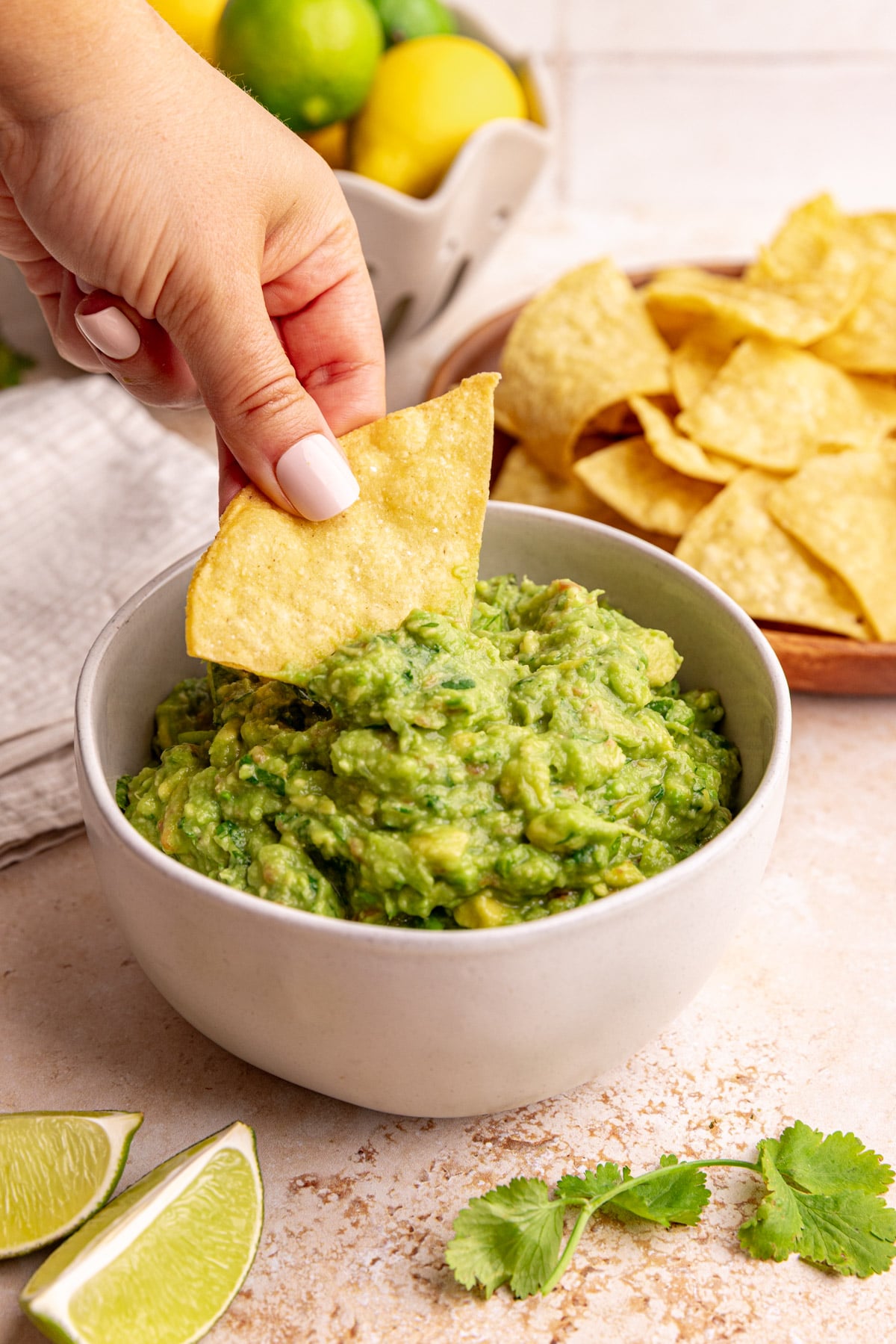 A tortilla chip scooping some guacamole.