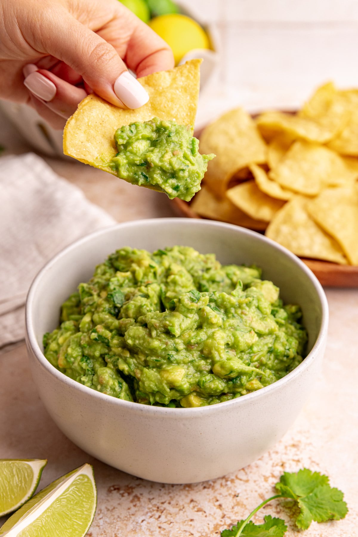 A tortilla chip scooping some guacamole.