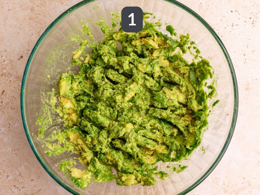 Guacamole step 1 - mash the avocados.