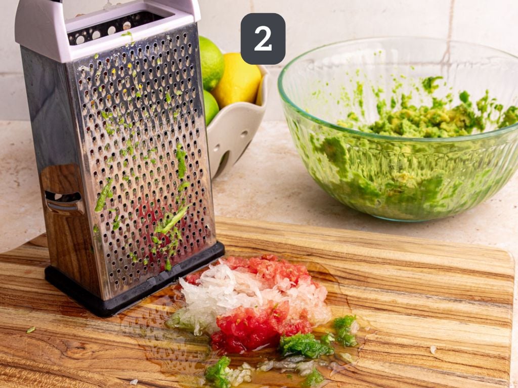 Guacamole step 2 - grate the onion, tomato, and jalapeño