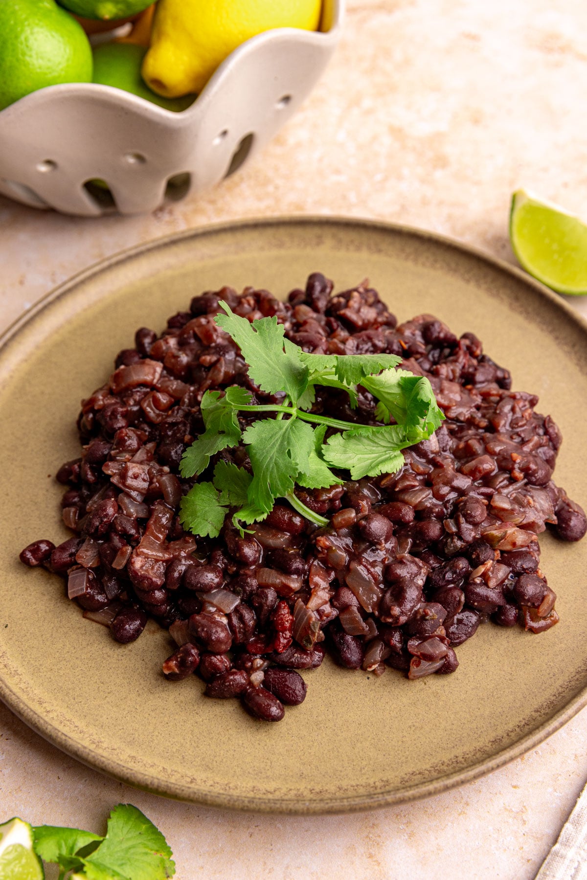 A plate of homemade chipotle style black beans, garnished with fresh cilantro.
