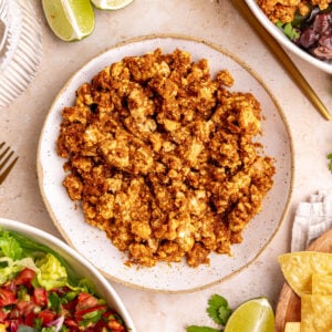 A bowl of homemade sofritas next to two chipotle-style burrito bowls.