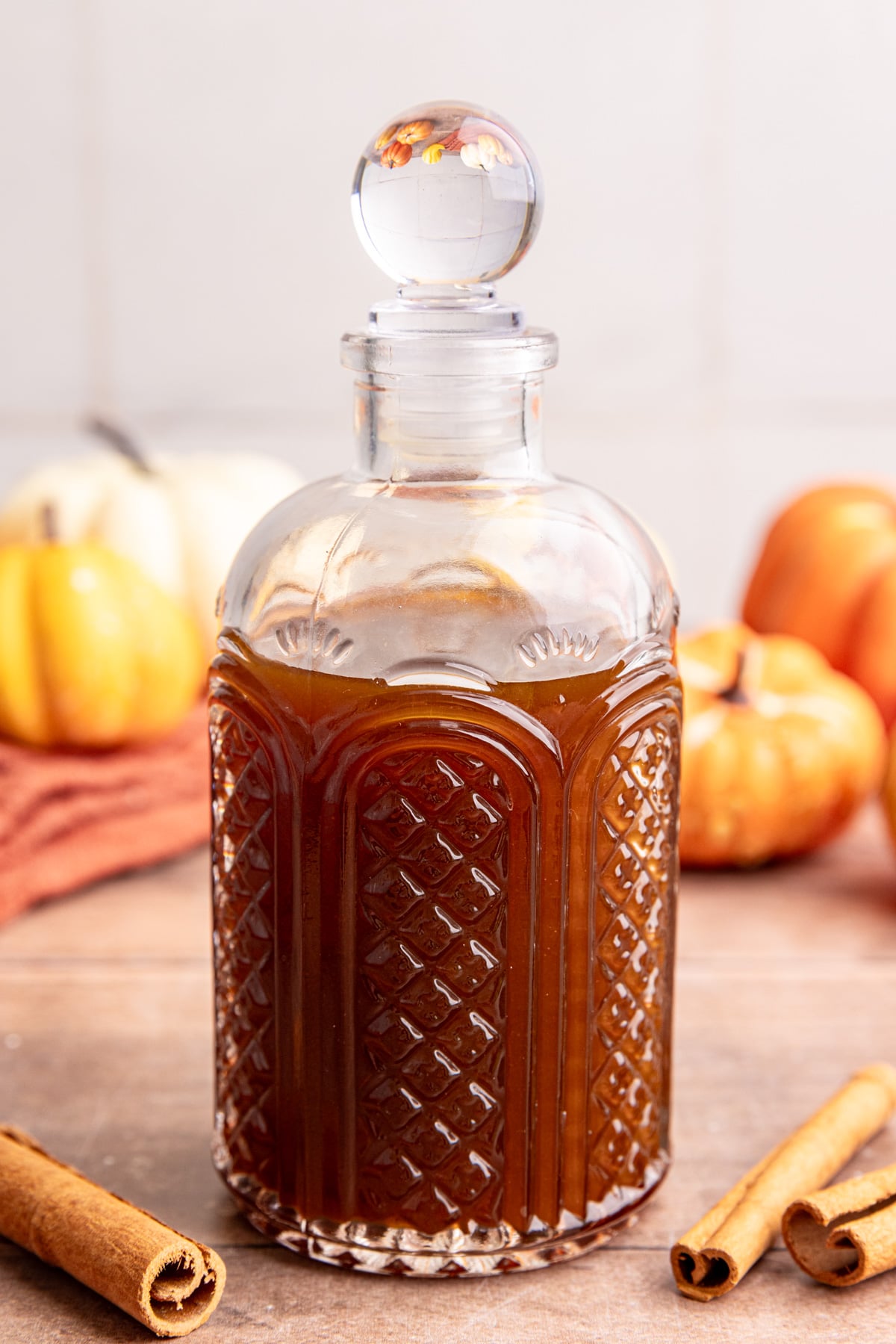 A bottle of Starbucks-Style Pumpkin Spice Syrup, without sweetened condensed oat milk mixed in.