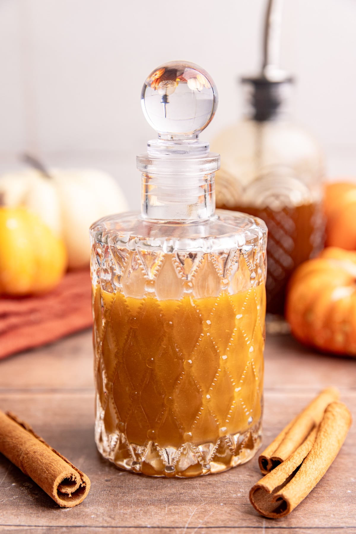 A bottle of Starbucks-Style Pumpkin Spice Syrup, with sweetened condensed oat milk mixed in.