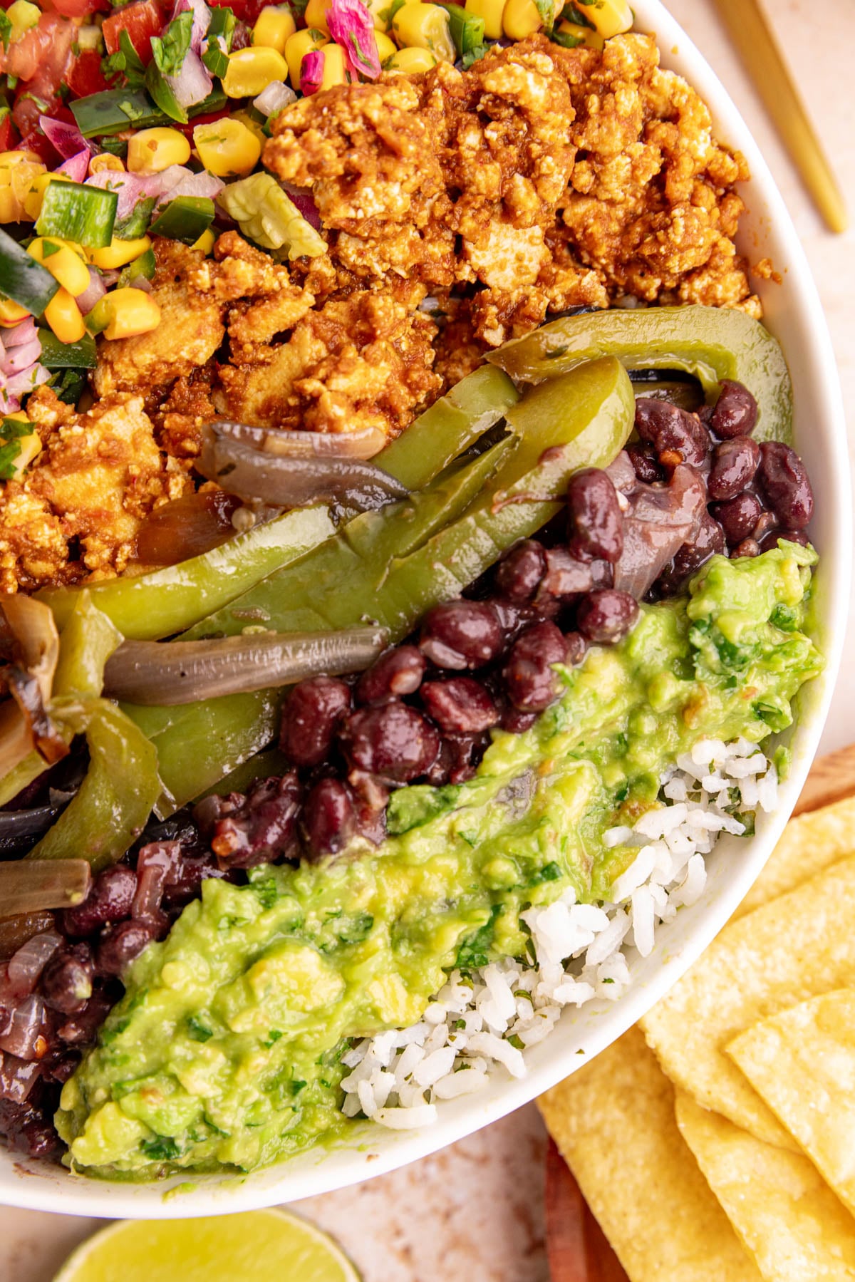 A homemade chipotle bowl, lined with chipotle inspired ingredients.
