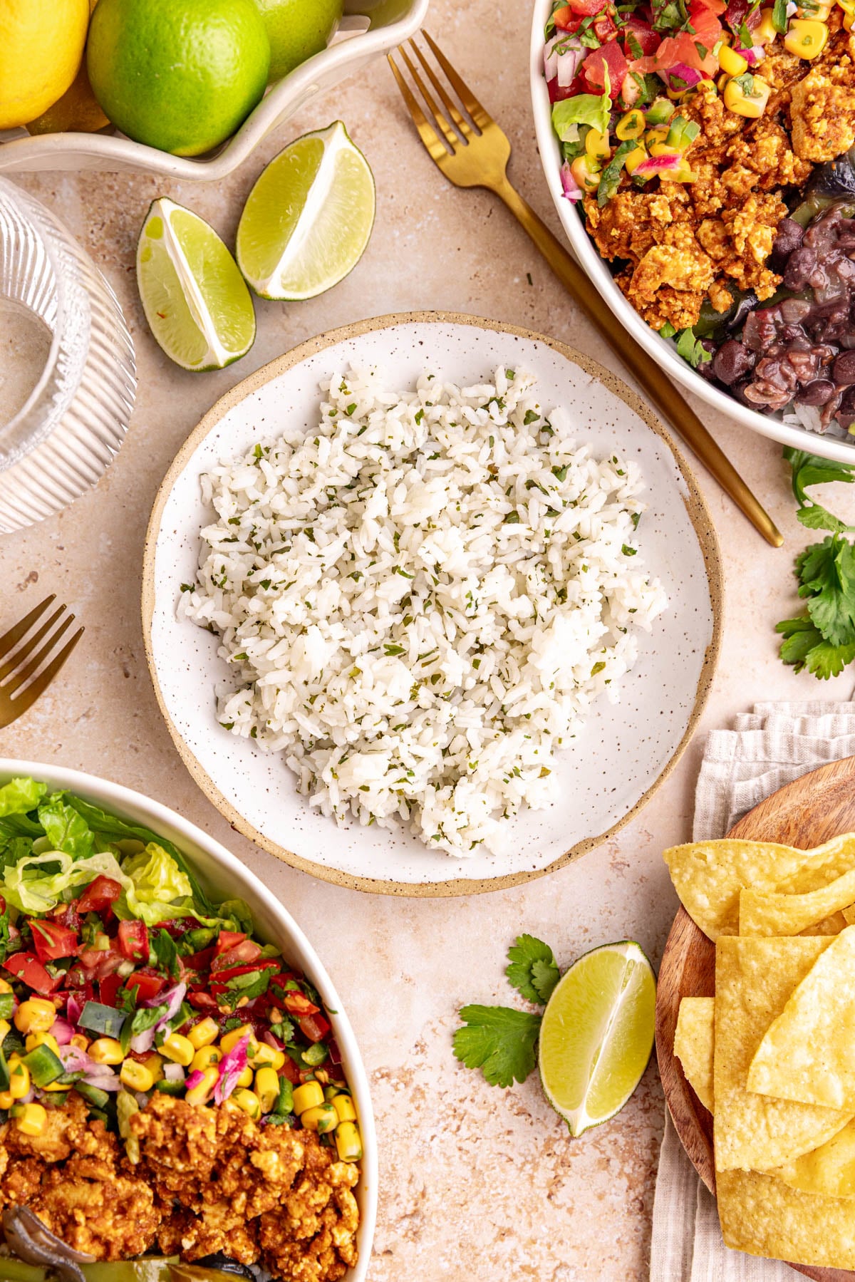 A bowl of homemade cilantro lime rice, next to two Chipotle style bowls.