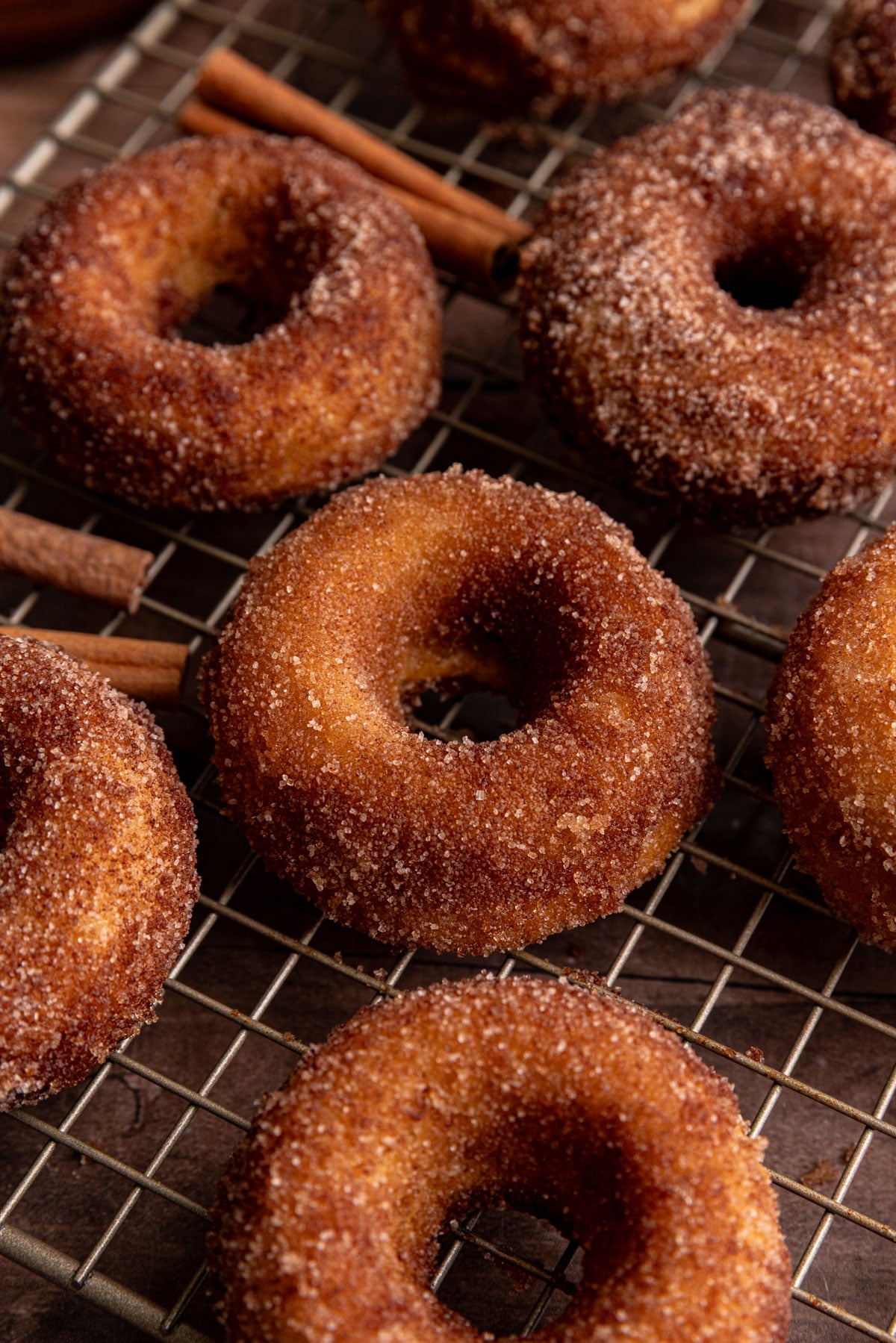 A few vegan cake donuts on a wire rack.