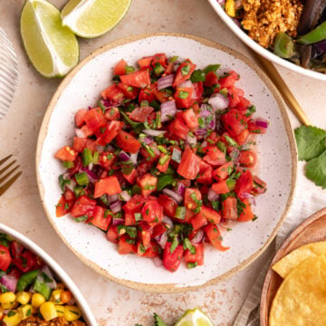 A bowl of Homemade tomato salsa, next to two chipotle bowls.