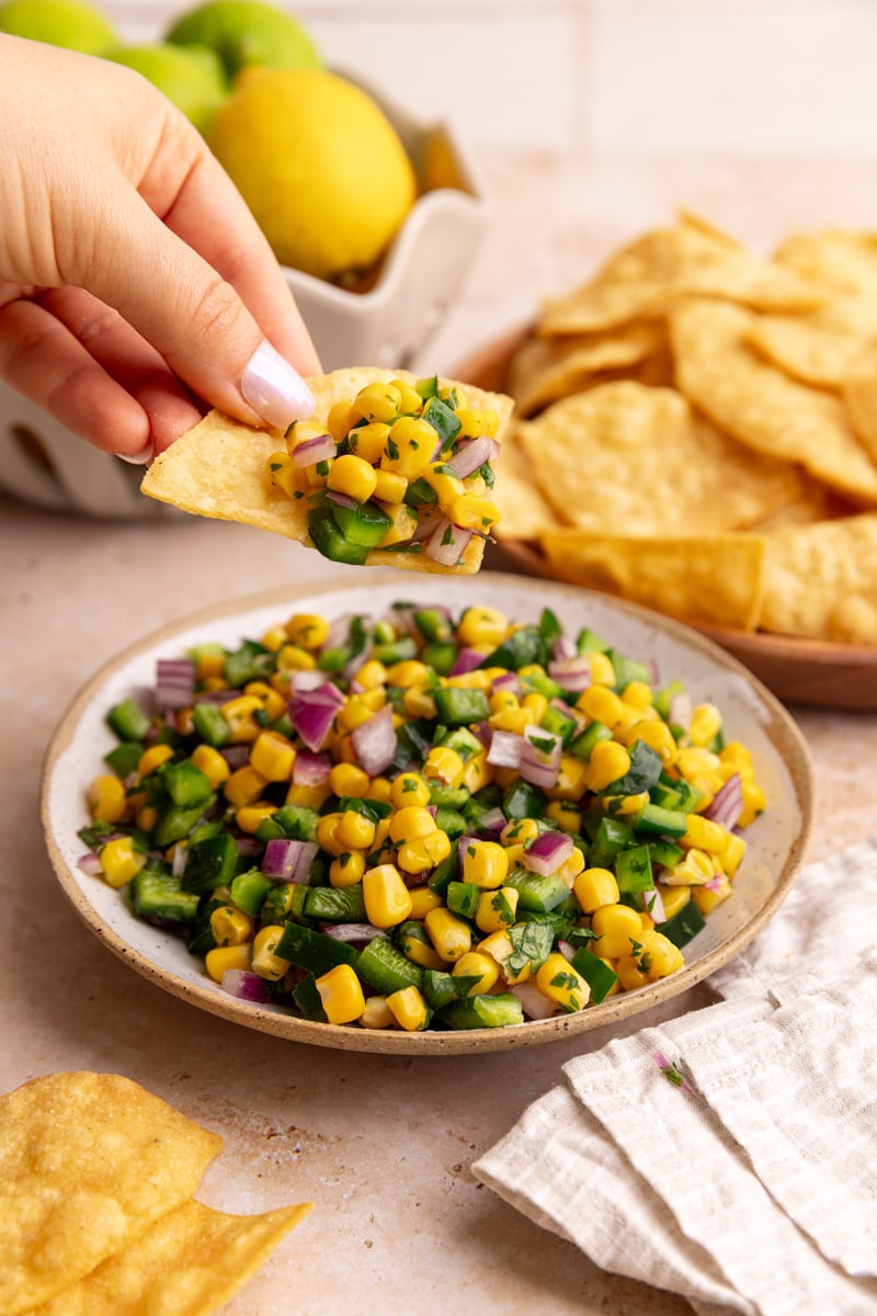 A chip scooping a bit of Homemade Chili Corn Salsa