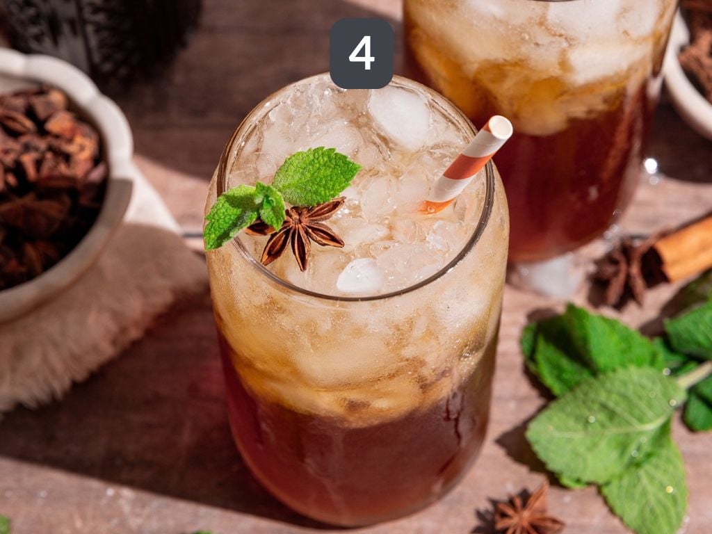 Homemade root beer step 4 - pour syrup over ice and top with sparkling water to make a root beer.