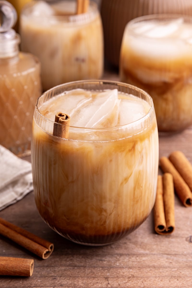 An iced horchata oat milk shaken espresso, garnished with a cinnamon stick.