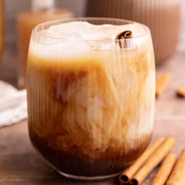 An iced horchata oat milk shaken espresso, garnished with a cinnamon stick.