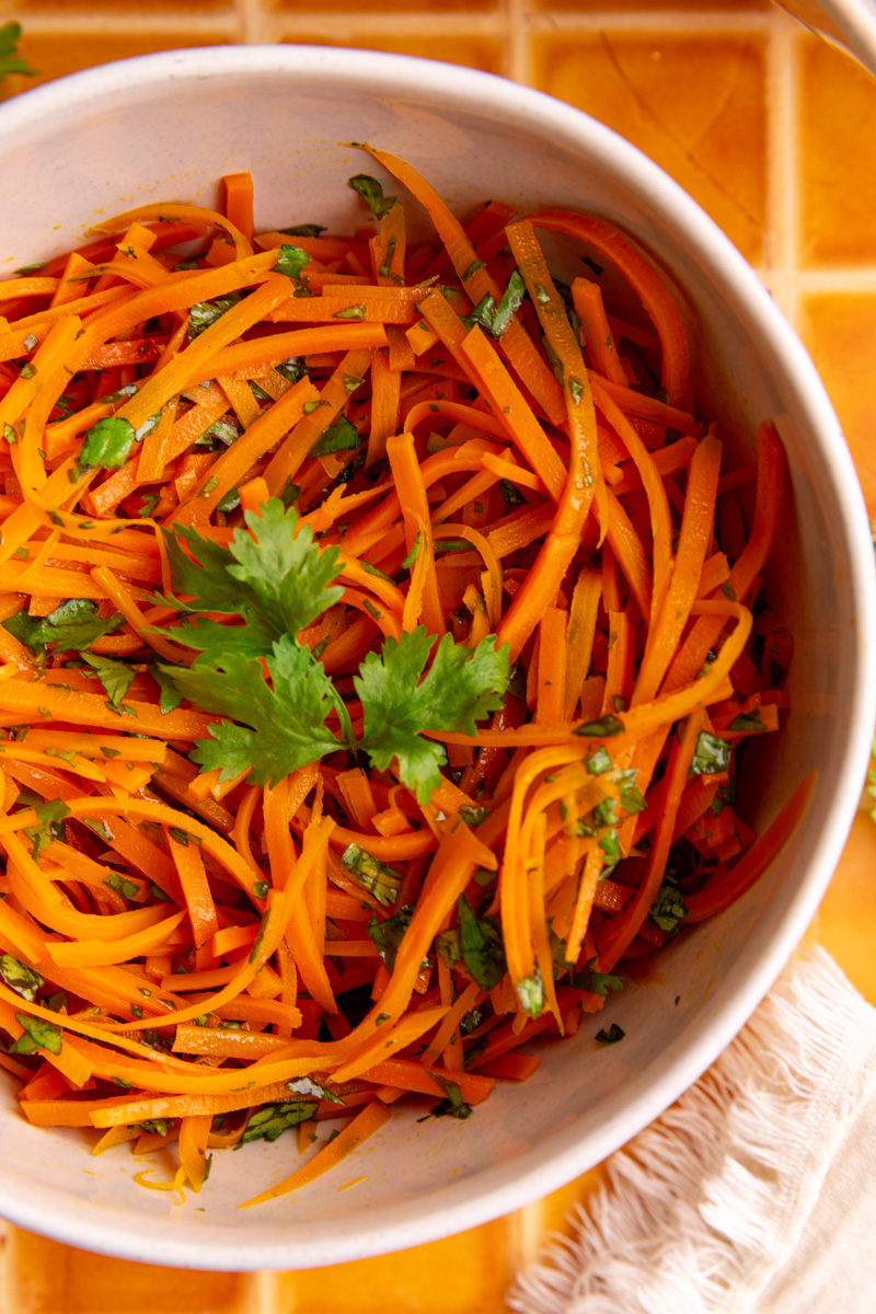 A bowl of bibibop style sesame carrots.