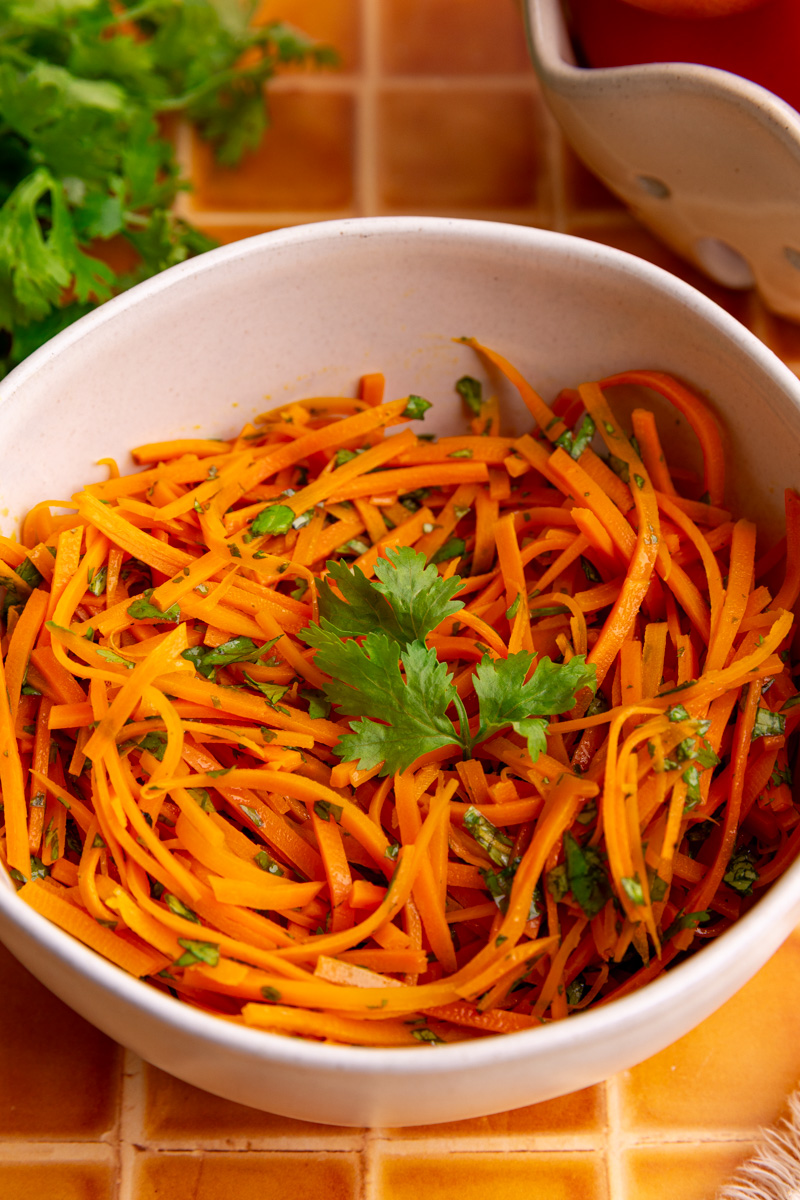 A bowl of bibibop style sesame carrots.