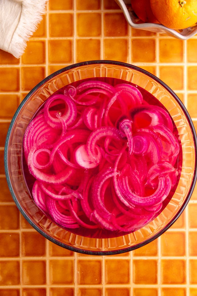 A bowl of pickled red onions.