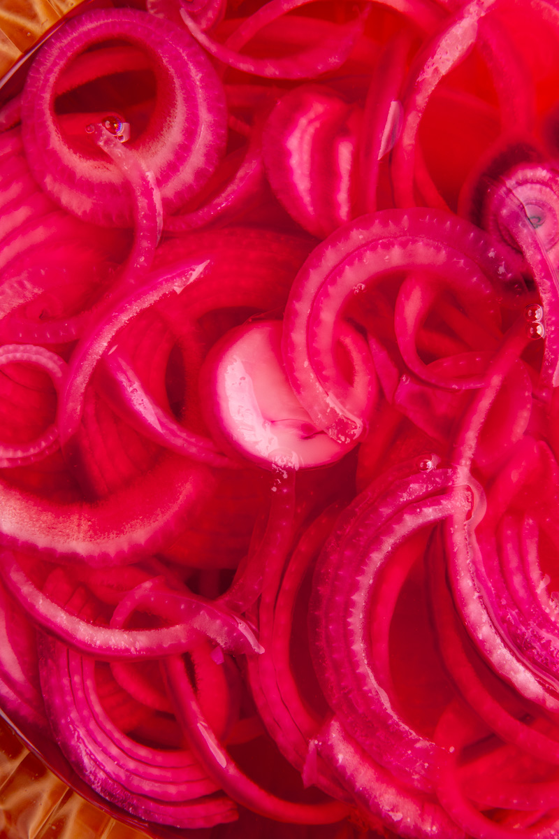 A bowl of pickled red onions.
