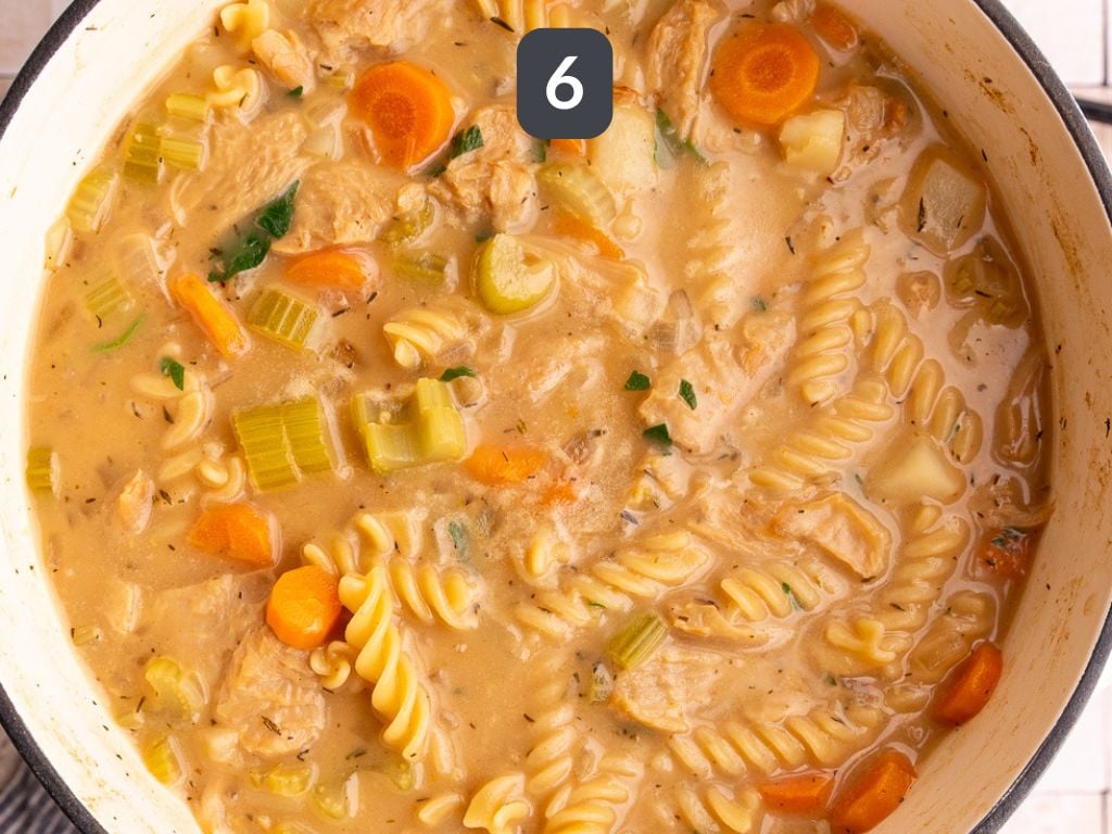 Vegan Creamy Chicken Noodle Soup Step 6 - stir in the chicken and cream cheese.