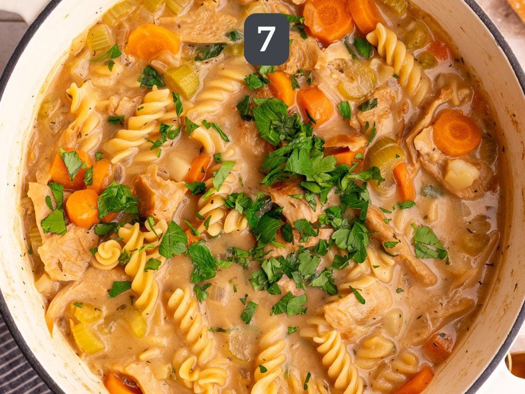 Vegan Creamy Chicken Noodle Soup Step 7 garnish with fresh parsley.